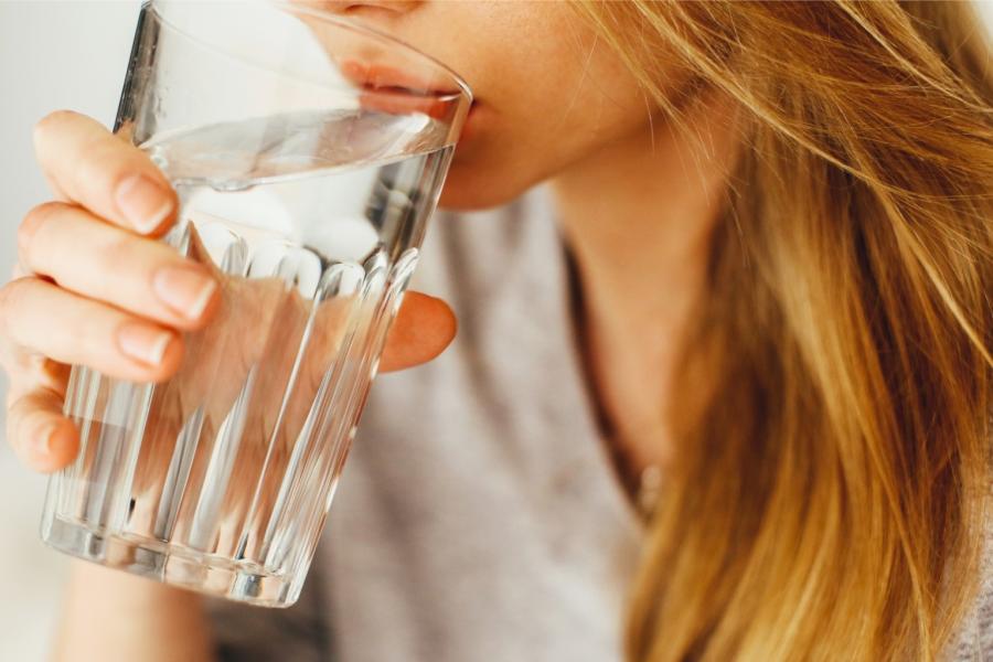 Close up of a woman drinking water from a glass