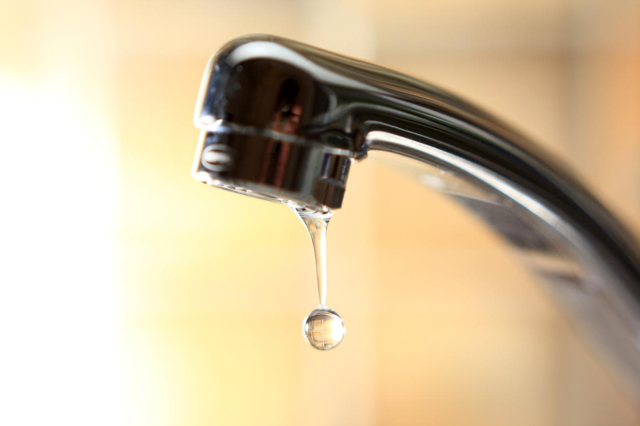 Close up of a faucet with water dripping from it