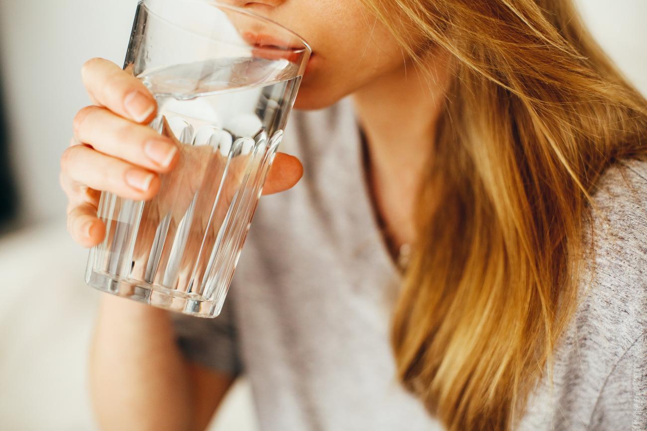 A woman drinking a glass of water