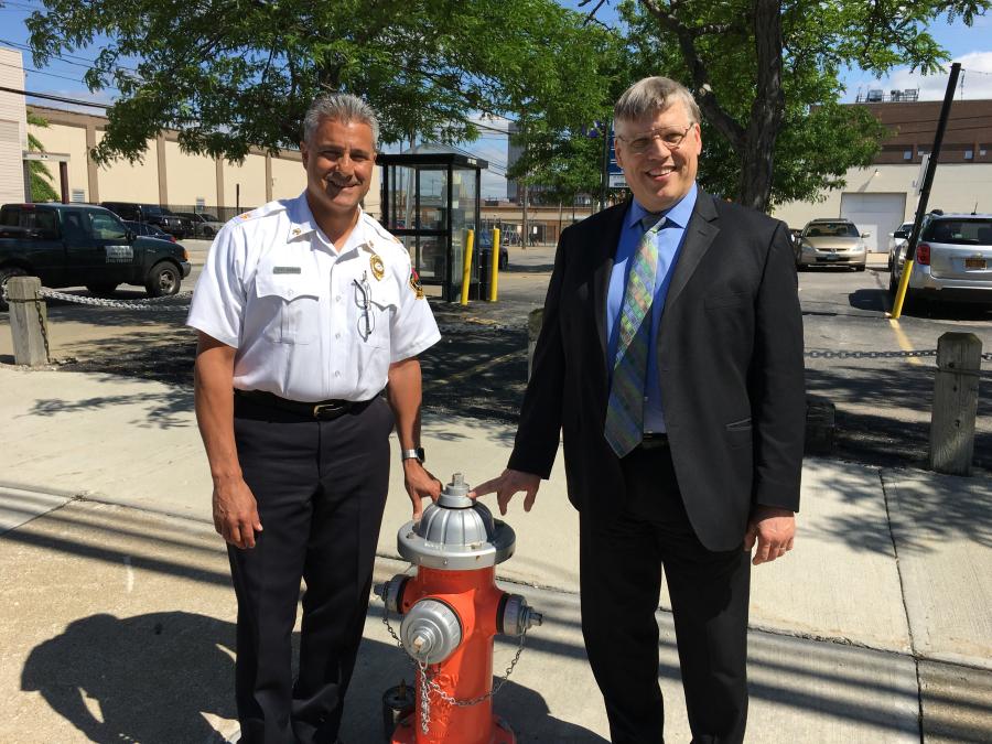 Cleveland Fire Chief Angelo Calvillo and Commissioner of Water Alex Margevicius stand next to a fire hydrant on a city street